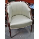 An Edwardian mahogany framed armchair with reeded legs.