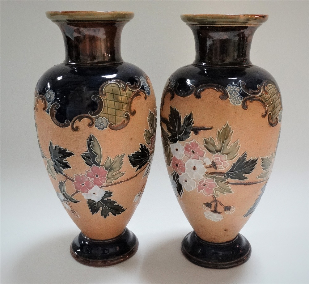 A pair of Doulton Lambeth Slaters Patent vases, tubeline decorated with blossoming branches upon a