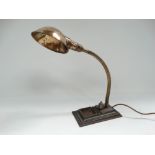 An early 20th century industrial swan neck brass adjustable table lamp upon cast iron base by