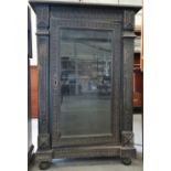 A late 19th century continental hardwood and carved alcove cabinet with glazed door, width 85cm.