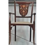 An Edwardian mahogany and inlaid armchair.