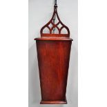 A George III style mahogany wall mounted candle box of waisted form with a fretted hanging bar,