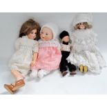 A German porcelain boy doll, together with an Armand Marseille 351/8.K. sleep eye doll and two other