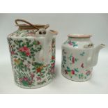 Two Chinese famille rose cylindrical teapots, the largest height 17cm.