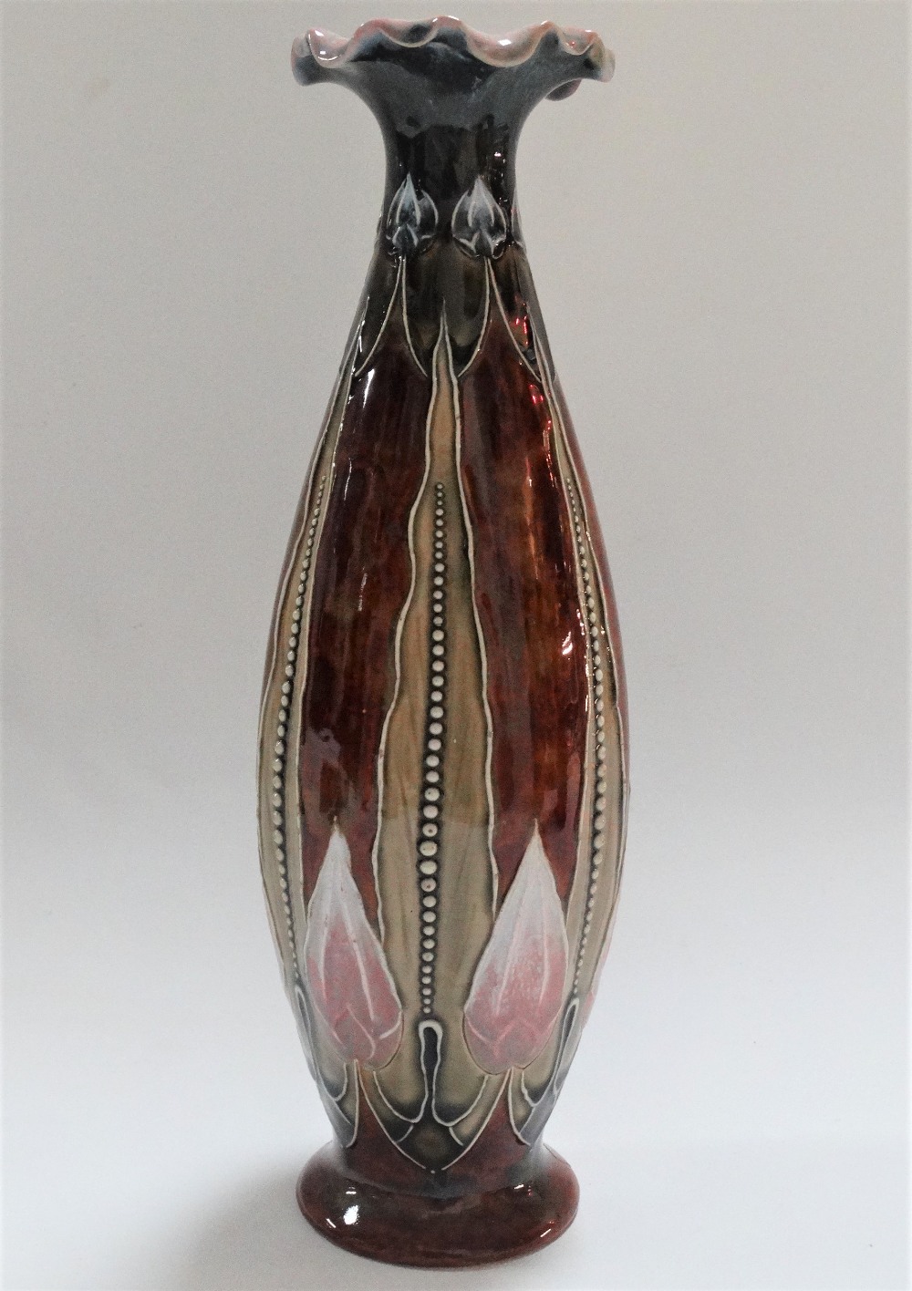 A Royal Doulton stoneware vase with tubeline decoration, impressed marks and No.428, height 28cm.