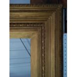A large giltwood picture frame, 142 x 95cm.