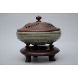 A Celadon incense burner on a wooden base, Ming period (dia 27cm) (*)