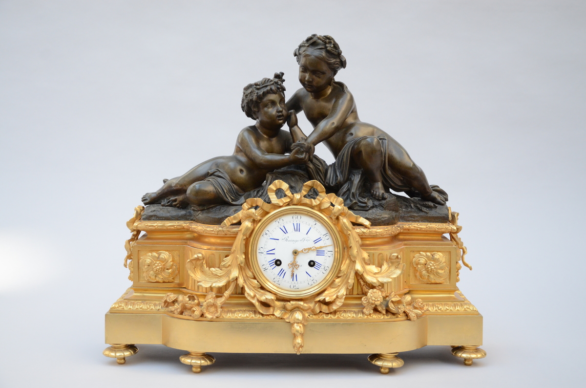 Gilt bronze clock 'putti', by Raingo FrËres ‡ Paris (44x50x15cm)