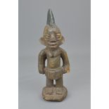 AN AFRICAN CARVED WOODEN FIGURE