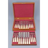 A SET OF TWELVE SILVER PLATED FISH KNIVES AND FORKS WITH IVORY HANDLES