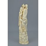 A LARGE JAPANESE IVORY FIGURE OF OLD MAN AND CHILD