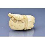 A Japanese ivory netsuke of tortoise and rat. Signature underneath. Length approx. 40 mm.
