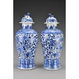 A pair of Chinese 19th Century blue and white porcelain vases and covers. Decorated with four-clawed