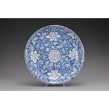 An 18th century Chinese porcelain dish decorated with peony scrolls and a central chrysanthemum,
