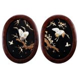 A pair of Japanese Shibayama lacquer panels. Each decorated in high relief with shell, mother-of