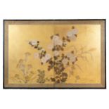 A Japanese bi-folding screen painted with flowers on a gilt ground. Framed in lacquered wood with