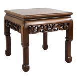 A Chinese carved side table with burr top and scrolled legs. Height 51.5 x width 52 x depth 52 cm.