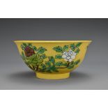 A Chinese yellow-ground porcelain bowl decorated with flower branches and butterflies. The body with