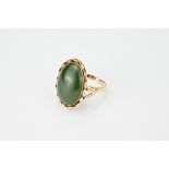 A 14K yellow gold ring with 'rope twist' design inserted with a green stone cabochon, possibly jade.