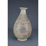 A Chinese Cizhou-type pear-shaped vase. The vase with carved decoration of scrolling peonies. Height