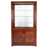 A Chinese carved hardwood glazed display cabinet with side doors, three glass shelves and two-door