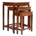 A Chinese hardwood nest of three side tables with stretcher legs. Largest table height 56 x width 61