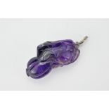 A Chinese carved amethyst 'melon' pendant. The stone in a deep purple colour with a white meal