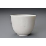 A Chinese 17th century incised Dehua wine cup. The blanc de Chine cup raised on a shallow foot