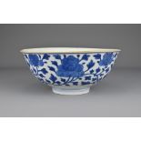 A Chinese early 19th Century blue and white porcelain bowl. The exterior decorated with scrolling