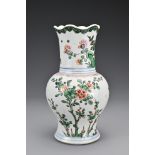 A Chinese 18th Century wucai porcelain vase. The body with a lobbed rim decorated in a floral design