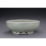 A Chinese 18/19th century carved celadon-glazed porcelain censer. The exterior carved with floral