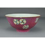 A Chinese early 19th Century sgraffito ruby-ground porcelain bowl. The exterior decorated with