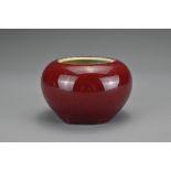 A Chinese red-glazed porcelain brush washer. The globular pot covered in a dark reddish glaze.