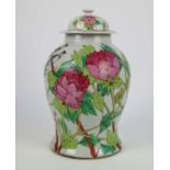 A Chinese vase with floral design and cover