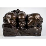 A patinated plasted sculpture of 3 children heads