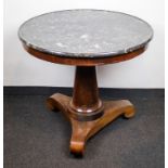 A round table with marble top on a central feet