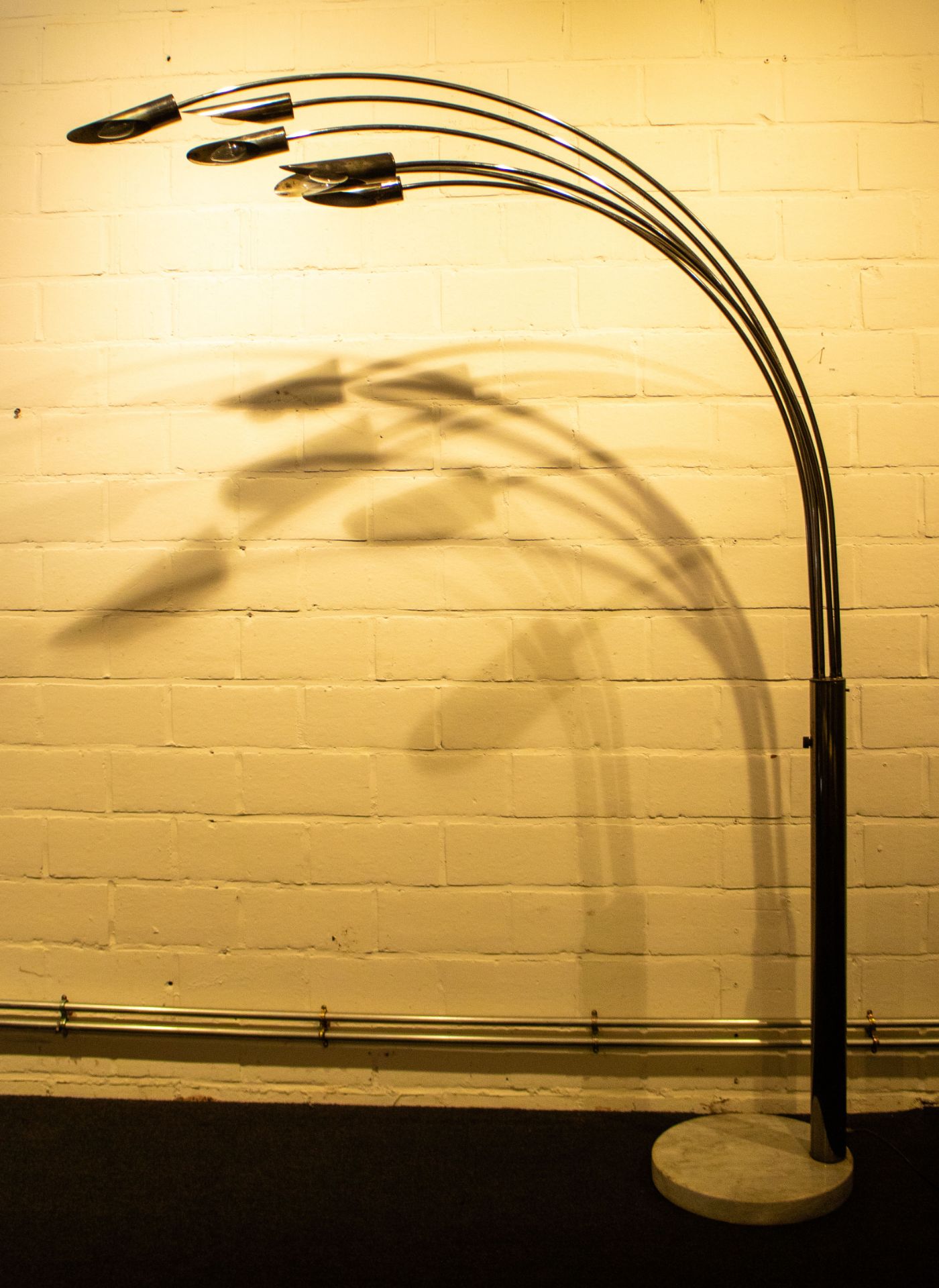 A large vintage chromed arc floor lamp with six overhanging arms