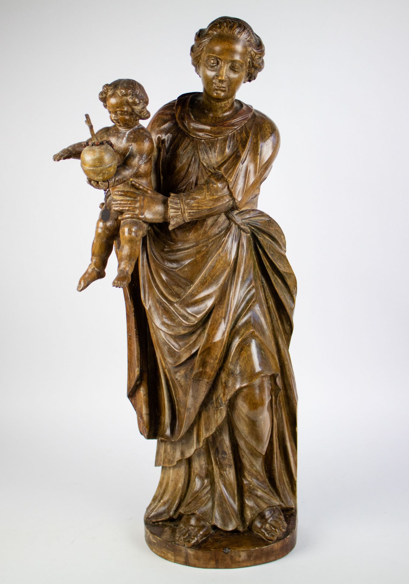 Statue of Virgin Mary carrying Jesus, with globe in his hand