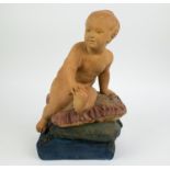 A patinated plaster sculpture of a child on a pillow