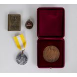 A collection of a relic, medal and badge