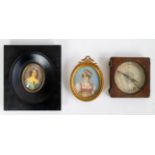 A collection of 2 miniatures and a compass