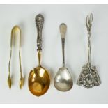 A collection of 2 silver spoons, sugar tongs and cookie tongs