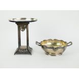 A silver dish on 4 silvered columns and a silver bowl.