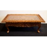 A fine wood sculpted Oriental coffee table