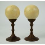 Couple ivory billiard balls on wooden base