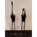 Metal storks as garden ornaments
