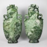 A pair of Chinese lidded vases in natural stone with jade look