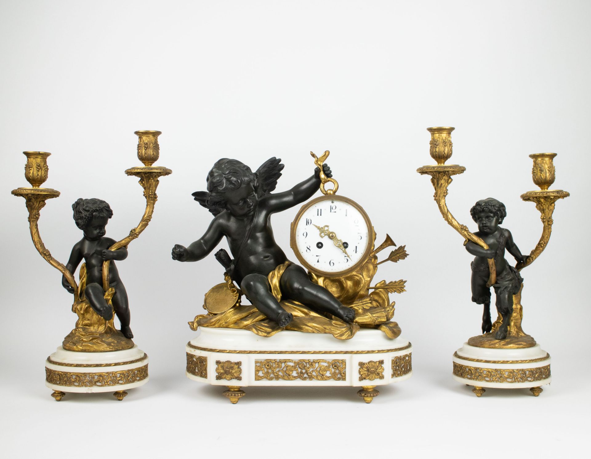 A Louis XVI style clock and candelabra in marble and bronze