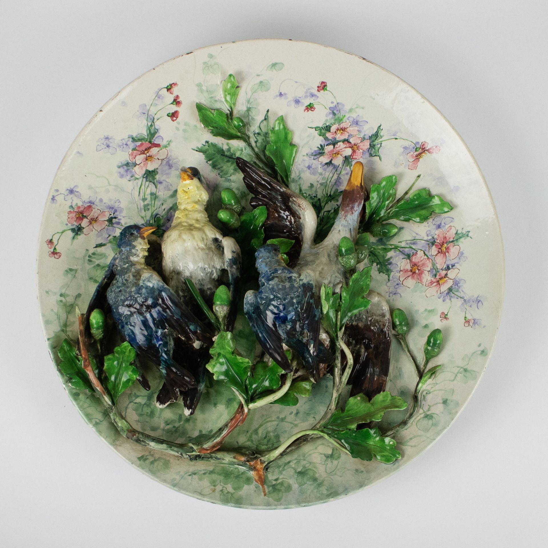 Large antique dish in barbotine with birds