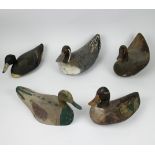 A collection of 5 wooden decoy ducks